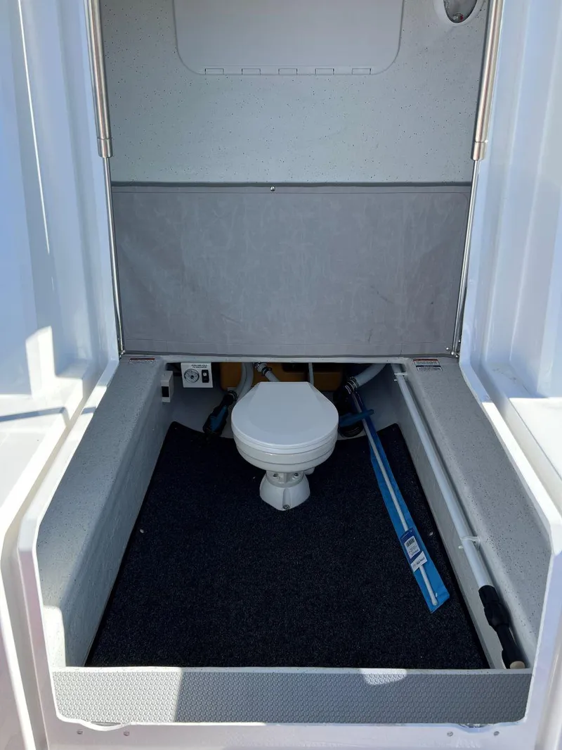 Slide: The Image of 2023 Protector 250 Chase boat interior with compact toilet and storage area. - 5