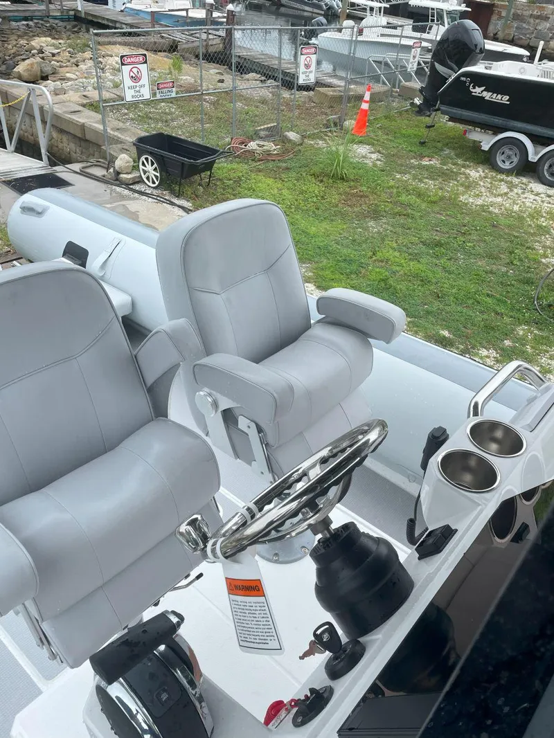 Slide: The Image of 2023 Protector 250 Chase boat interior with dual seats and steering wheel. - 9