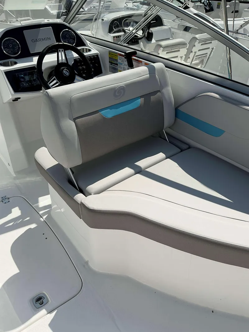 Slide: The Image of 2025 Hurricane 235 SD boat interior with steering wheel and cushioned seating. - 10
