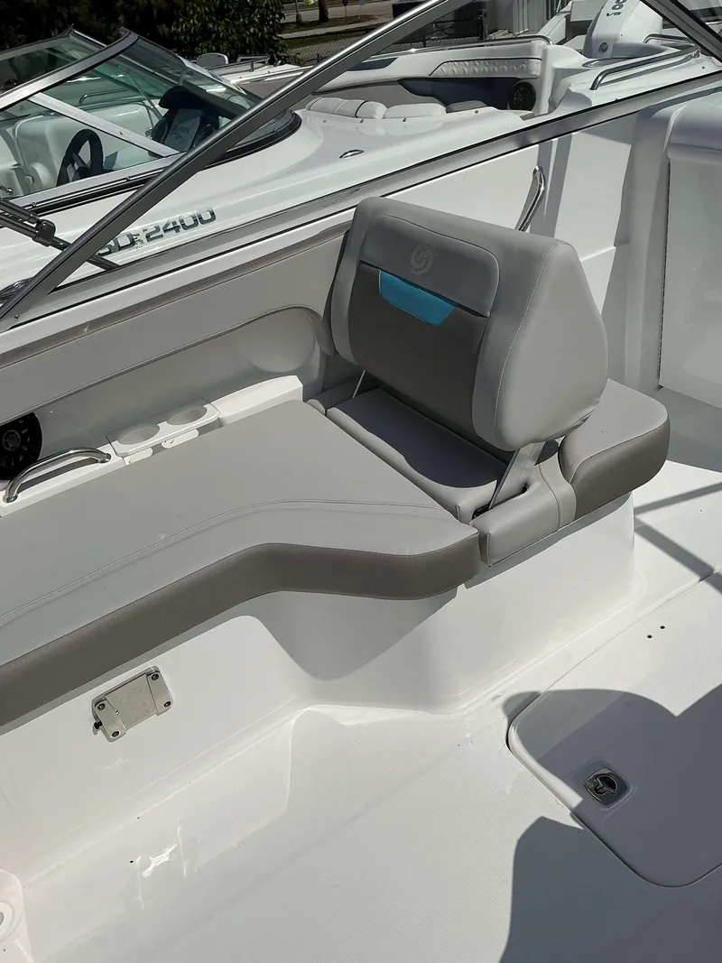 Slide: The Image of 2025 Hurricane 235 SD boat interior with gray seating and cup holders. - 11