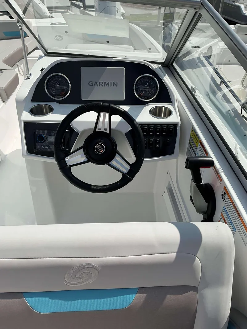 Slide: The Image of 2025 Hurricane 235 SD boat dashboard with Garmin display and steering wheel. - 9