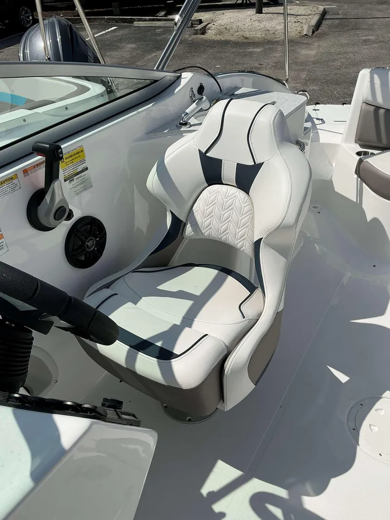 Slide: The Image of Captain's seat of 2025 Hurricane 2400 SD boat, featuring sleek white and black design. - 12