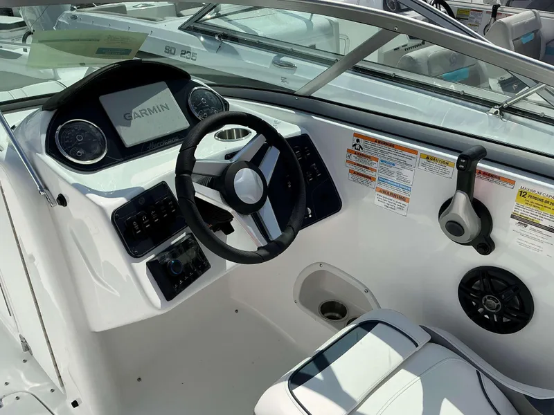 Slide: The Image of 2025 Hurricane 2400 SD boat dashboard with Garmin navigation system and steering wheel. - 6