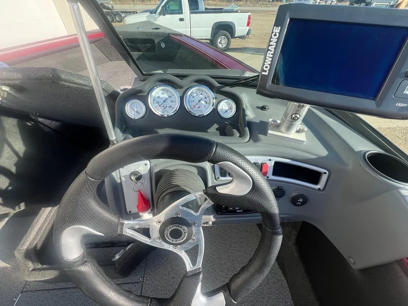 Slide: The Image of Steering console of 2014 Lund 1875 Crossover XS with gauges and Lowrance display. - 15