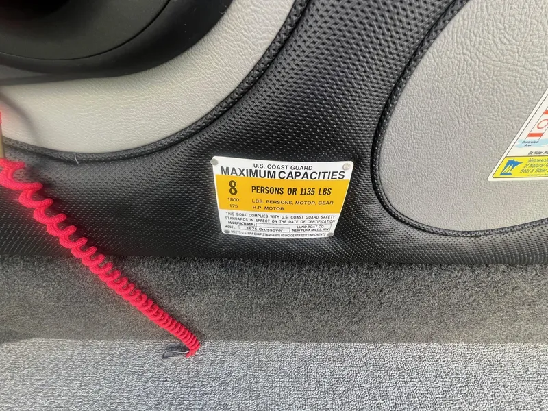 Slide: The Image of 2014 Lund 1875 Crossover XS boat capacity label, 8 persons or 1135 lbs limit. - 17