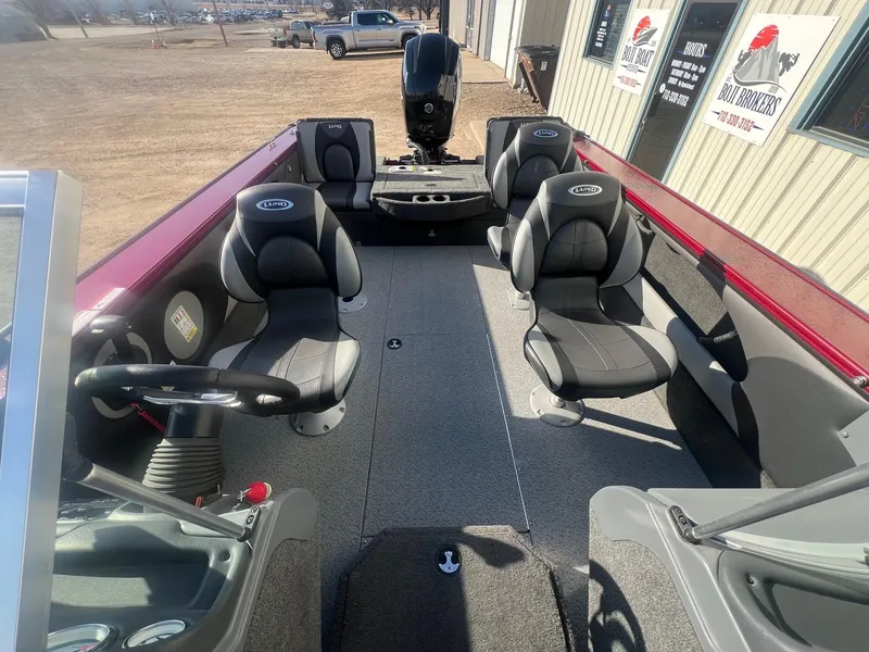 Slide: The Image of 2014 Lund 1875 Crossover XS boat interior with seating and steering wheel. - 19