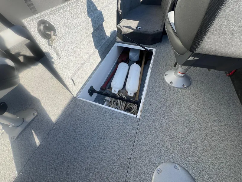 Slide: The Image of 2014 Lund 1875 Crossover XS boat interior with open storage compartment and safety equipment. - 20