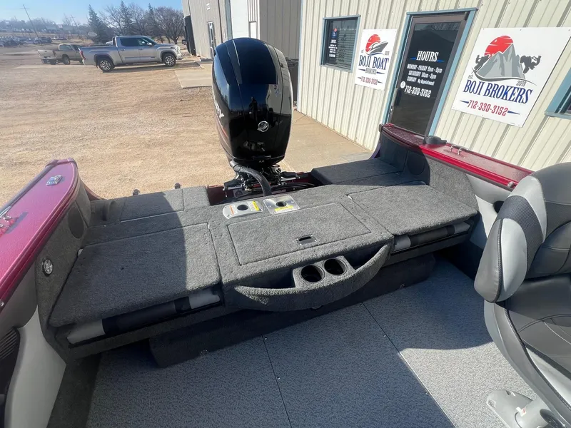 Slide: The Image of 2014 Lund 1875 Crossover XS boat interior with Mercury engine, parked outside dealership. - 23