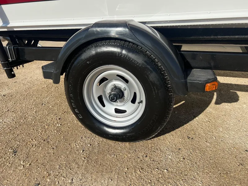 Slide: The Image of Trailer wheel of a 2014 Lund 1875 Crossover XS on gravel surface. - 24