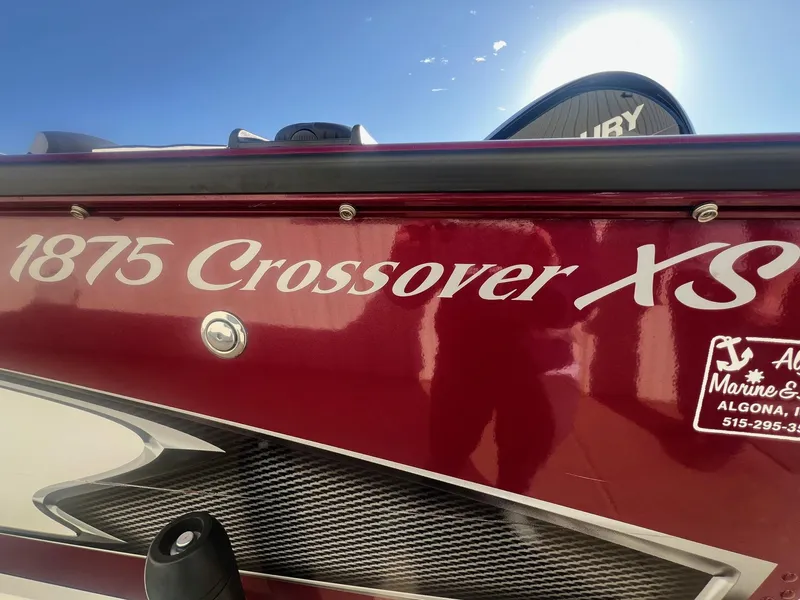 Slide: The Image of 2014 Lund 1875 Crossover XS boat with red exterior and visible branding. - 3