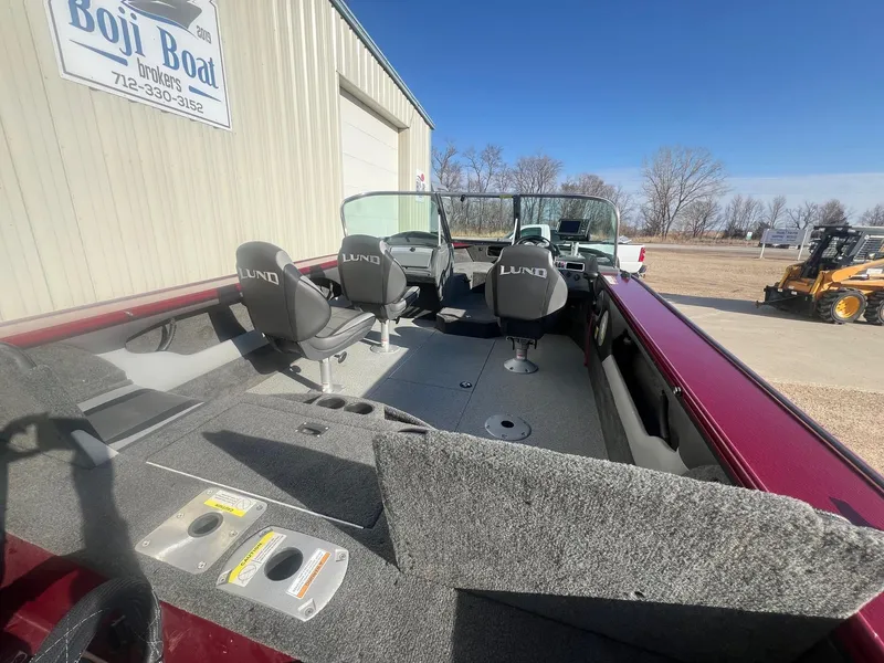 Slide: The Image of 2014 Lund 1875 Crossover XS boat interior with seating and dashboard, parked near Boji Boat Brokers. - 9