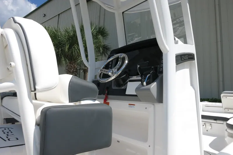 Slide: The Image of 2025 Robalo 246 Cayman boat console with steering wheel and seating. - 12