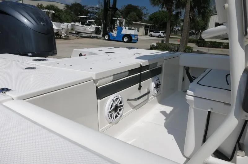 Slide: The Image of 2025 Robalo 246 Cayman boat interior with speakers and storage compartments. - 15