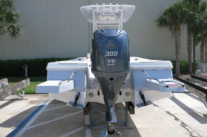 Slide: The Image of 2025 Robalo 246 Cayman boat with Yamaha 300 V6 engine, docked outdoors. - 6