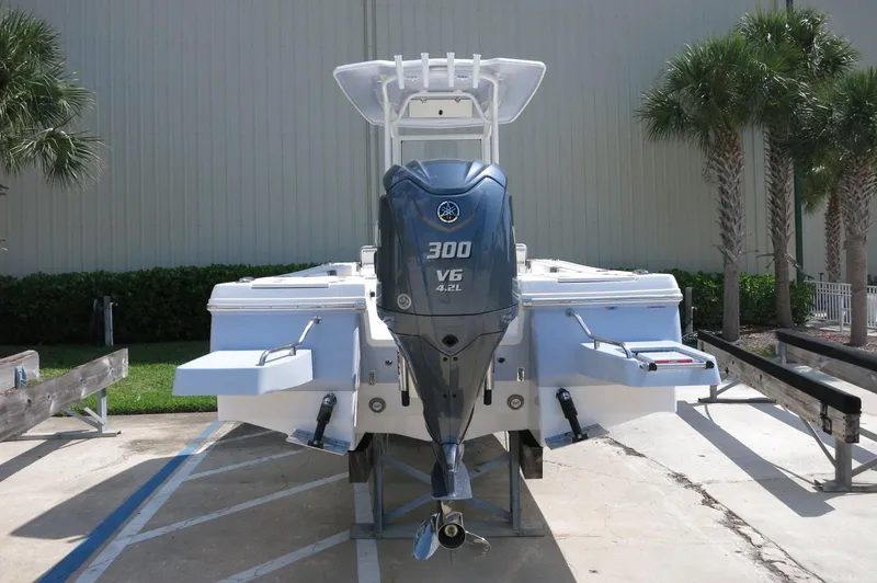 Slide: The Image of 2025 Robalo 246 Cayman boat with Yamaha 300 V6 engine, parked outdoors. - 9