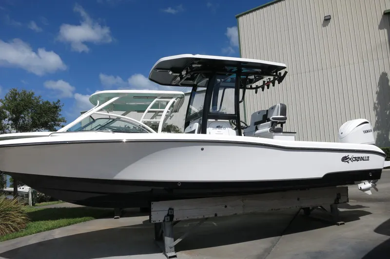 Slide: The Image of 2024 Crevalle 26 HCO boat displayed outdoors, featuring sleek design and modern features. - 1