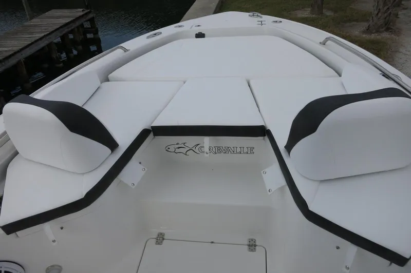 Slide: The Image of 2024 Crevalle 26 HCO boat with white cushioned seating and logo. - 10
