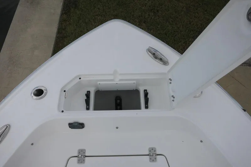 Slide: The Image of 2024 Crevalle 26 HCO boat bow storage compartment with open hatch. - 13