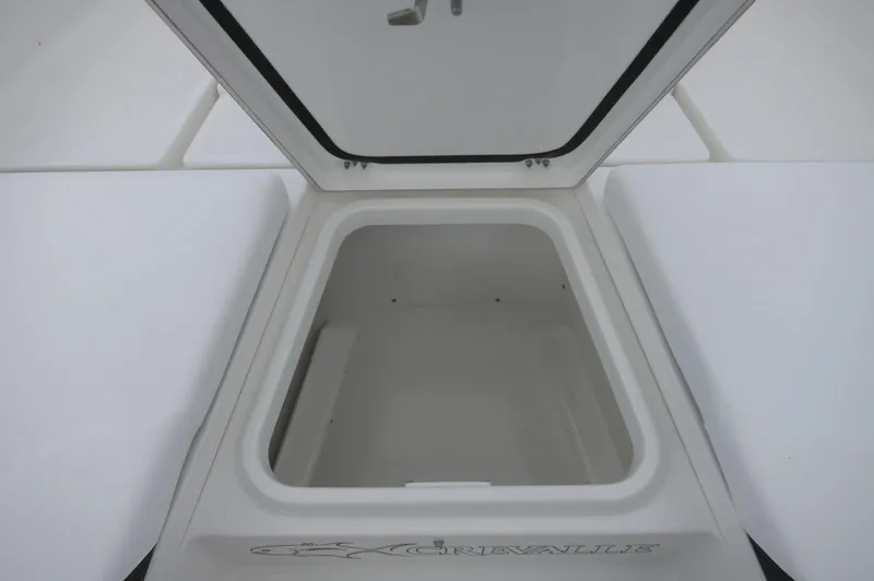 Slide: The Image of 2024 Crevalle 26 HCO boat storage compartment with open lid. - 15