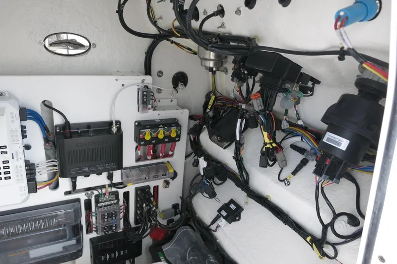 Slide: The Image of 2024 Crevalle 26 HCO boat wiring and electrical components in a compact compartment. - 18
