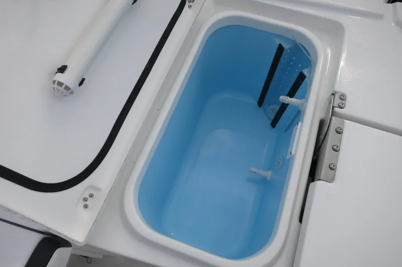 Slide: The Image of Livewell compartment on 2024 Crevalle 26 HCO boat, featuring a blue interior. - 24