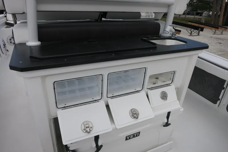 Slide: The Image of 2024 Crevalle 26 HCO boat with Yeti cooler and storage compartments. - 26