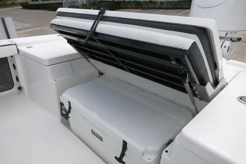 Slide: The Image of 2024 Crevalle 26 HCO boat with open storage compartment and cooler. - 27
