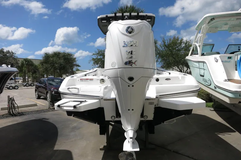 Slide: The Image of 2024 Crevalle 26 HCO boat displayed outdoors under a blue sky. - 3