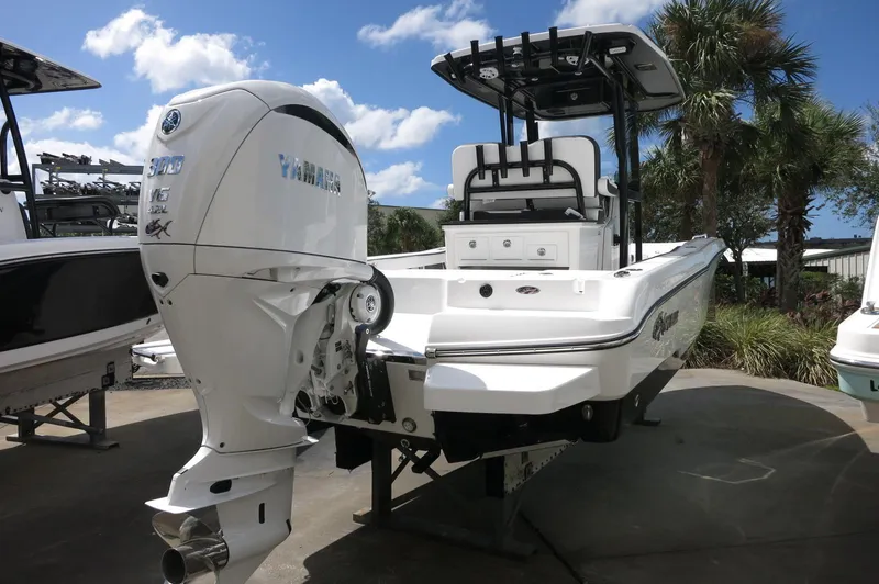 Slide: The Image of 2024 Crevalle 26 HCO boat with Yamaha outboard motor, docked under a clear blue sky. - 4