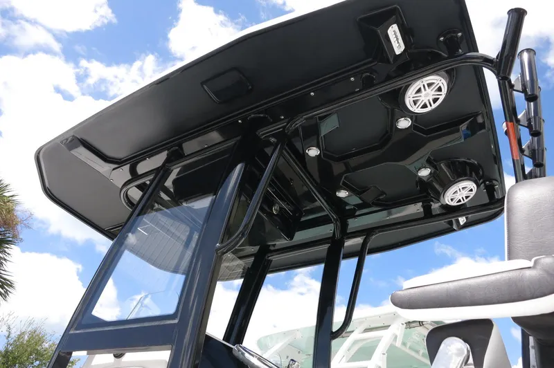 Slide: The Image of 2024 Crevalle 26 HCO boat with sleek black T-top and integrated speakers. - 5