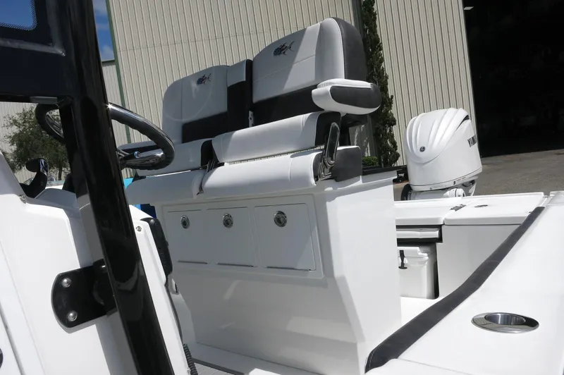 Slide: The Image of 2024 Crevalle 26 HCO boat interior with dual seating and storage compartments. - 7