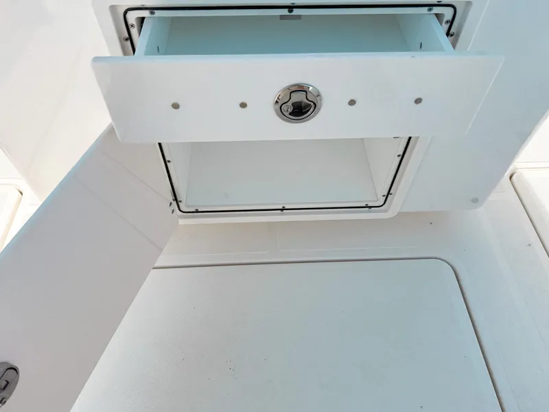 Slide: The Image of Open storage compartment on 2025 Pursuit S 268 Sport boat. - 12