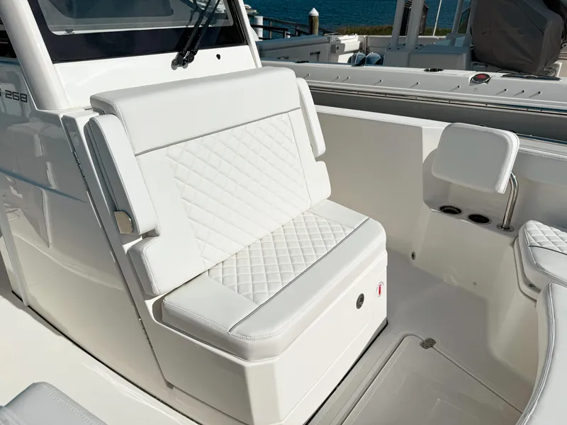 Slide: The Image of 2025 Pursuit S 268 Sport boat with white cushioned seating and sleek design. - 19