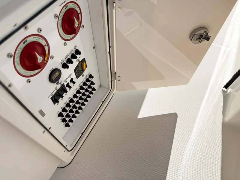 Slide: The Image of Control panel of 2025 Pursuit S 268 Sport boat, featuring switches and dials. - 21