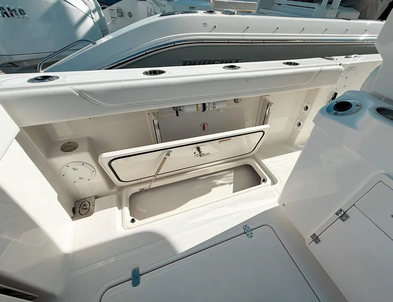 Slide: The Image of 2025 Pursuit S 268 Sport boat interior with open storage compartment. - 22