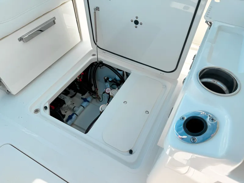 Slide: The Image of 2025 Pursuit S 268 Sport boat interior compartment with open hatch and storage features. - 23