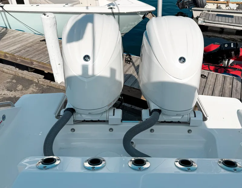 Slide: The Image of 2025 Pursuit S 268 Sport boat engines at dock, showcasing dual outboard motors. - 6