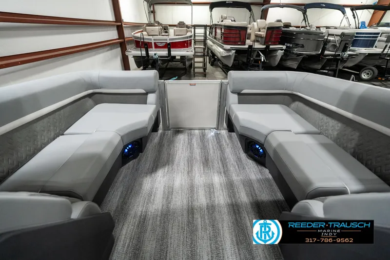 Slide: The Image of 2025 Bennington 22 MFB pontoon boat interior with gray seating in a showroom. - 15