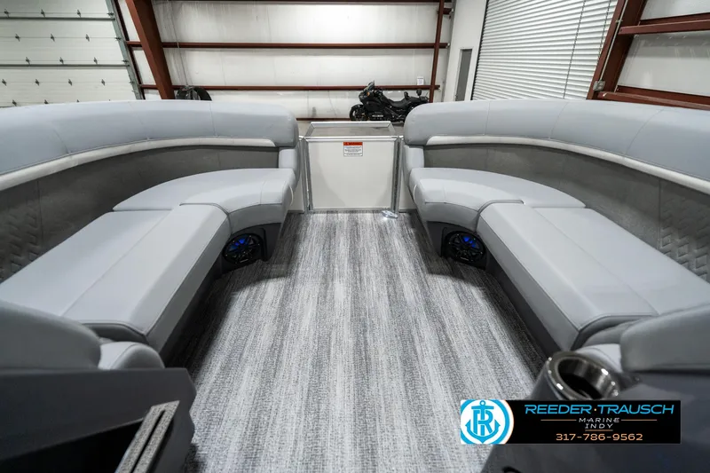 Slide: The Image of 2025 Bennington 22 MFB boat interior with gray seating and carpeted flooring. - 18
