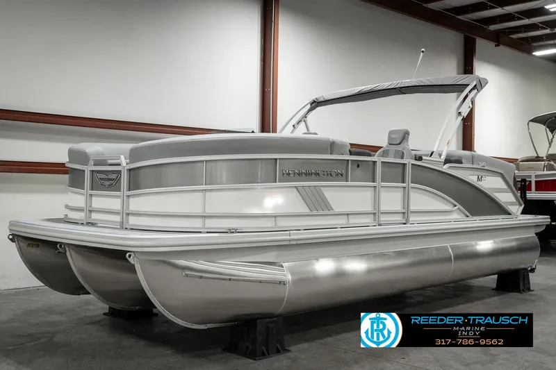 Slide: The Image of 2025 Bennington 22 MFB pontoon boat in showroom, featuring sleek design and modern amenities. - 2
