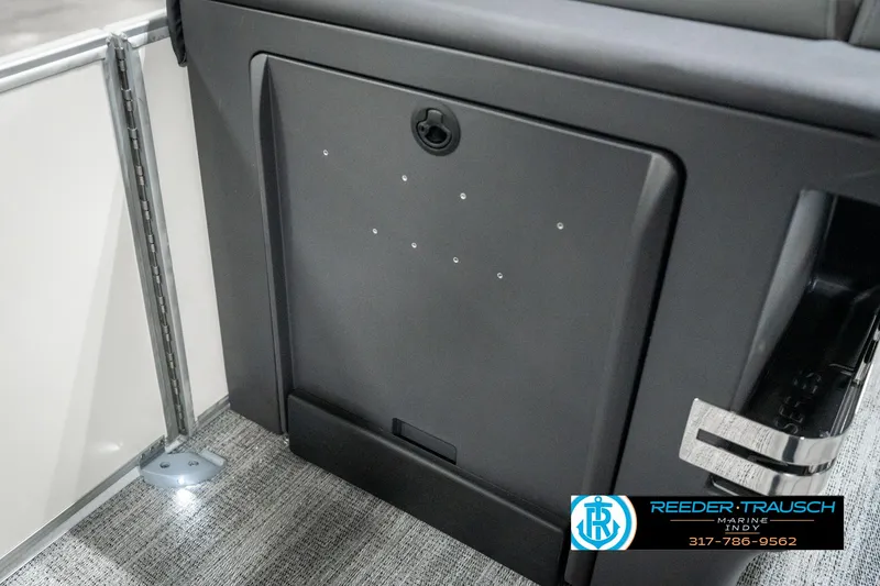 Slide: The Image of 2025 Bennington 22 MFB interior detail with storage compartment and carpeted flooring. - 22