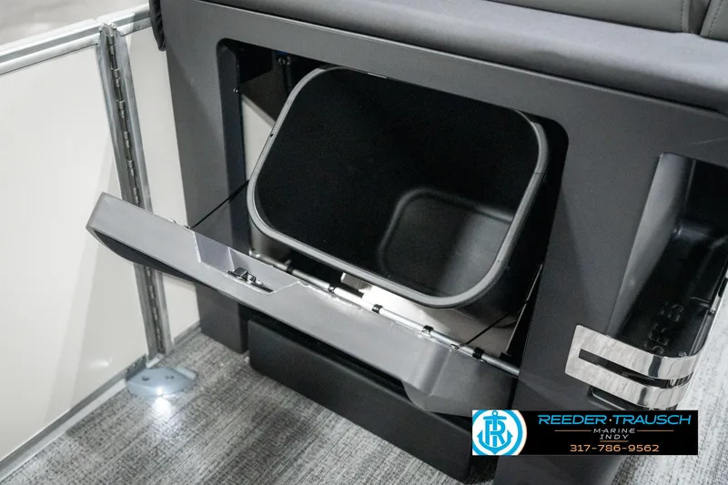 Slide: The Image of 2025 Bennington 22 MFB boat storage compartment with open hatch, showcasing interior space. - 23
