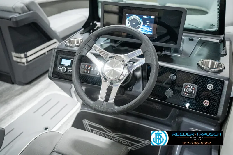 Slide: The Image of 2025 Bennington 22 MFB boat dashboard with steering wheel and digital display. - 26