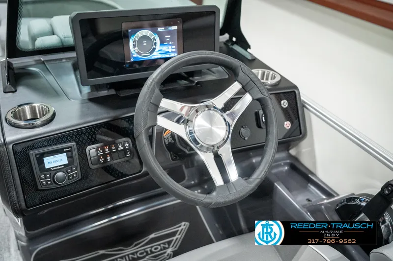 Slide: The Image of Steering wheel and dashboard of 2025 Bennington 22 MFB boat with modern controls. - 27