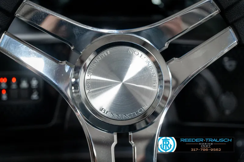 Slide: The Image of Steering wheel of 2025 Bennington 22 MFB boat, featuring sleek metallic design. - 28