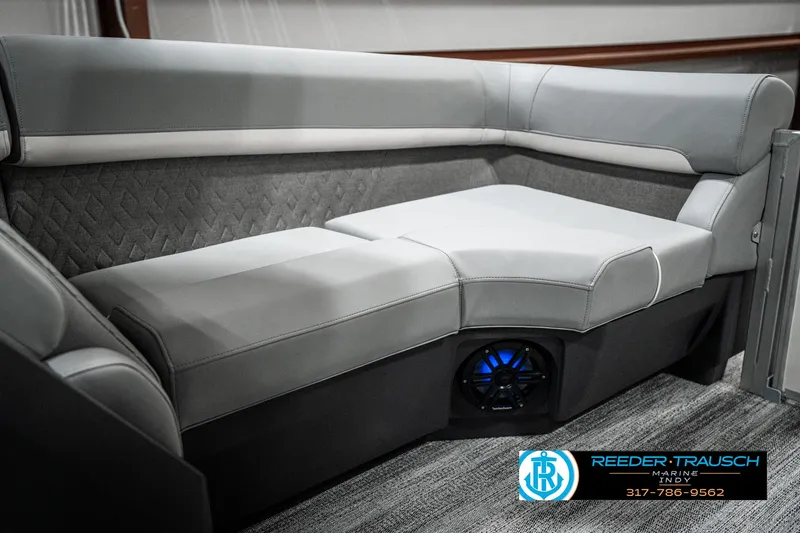 Slide: The Image of 2025 Bennington 22 MFB boat interior with gray cushioned seating and built-in speaker. - 35
