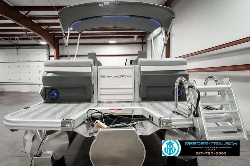 Slide: The Image of 2025 Bennington 22 MFB pontoon boat in showroom, featuring sleek design and modern amenities. - 7