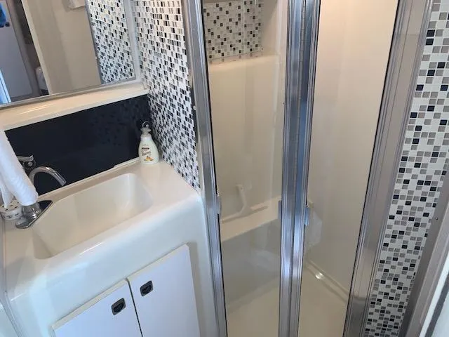 Slide: The Image of Bathroom interior of 1994 Silverton 34 Express yacht with modern sink and shower. - 19