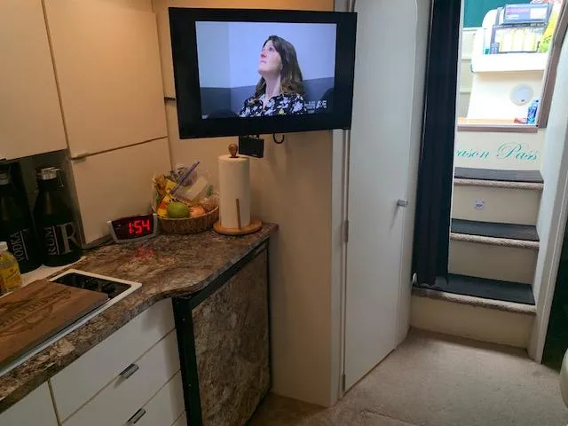 Slide: The Image of Interior of a 1994 Silverton 34 Express yacht with kitchen and TV. - 21