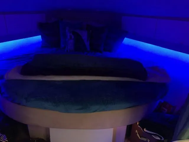 Slide: The Image of Cozy cabin interior of 1994 Silverton 34 Express with blue ambient lighting. - 27